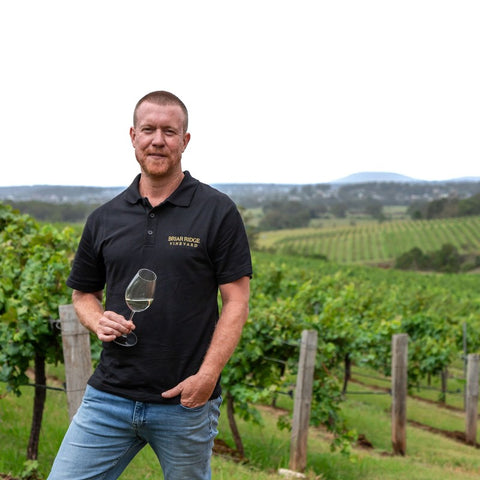 Briar Ridge's Andrew duff in his vineyard with a glass of white wine