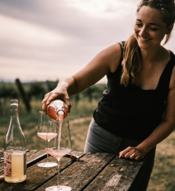 Wine producer Christina Netzl pours her fruity rose Pet Nat in the vineyard. A fitting setting for this natural wine. 