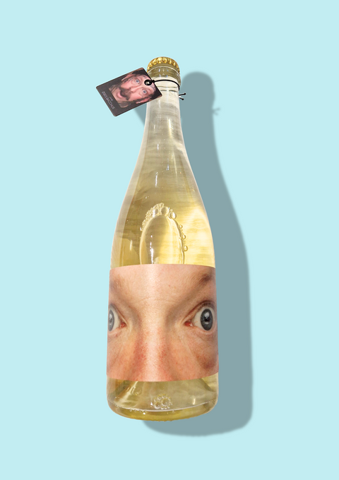 A bottle of Sparkling Jamie has an image of eyes on its label. This Pet Nat wine is a light golden colour with a crown cap.