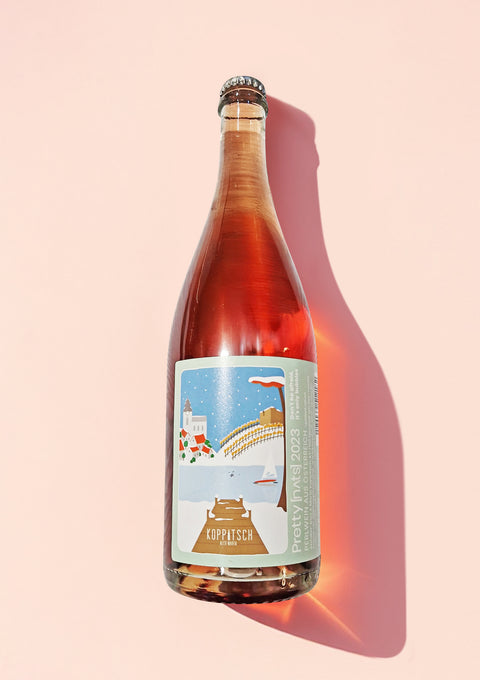A bottle of the 'Pretty' rose Pet Nat, made naturally with a vibrant bright pink colour.