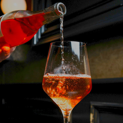 An interesting an exciting orange coloured rose sparkling wine being poured