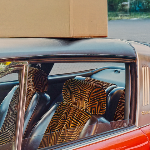 A Wildcase wine box being delivered by a retro classic car that demonstrates intrigue, excitement and style. 