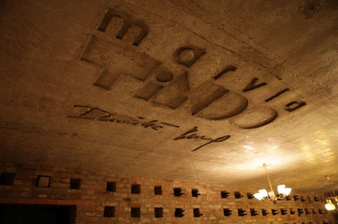 Marvla Tindo is engraved into the cellar ceiling, whilst caverns in the wall host bottles of wine. 